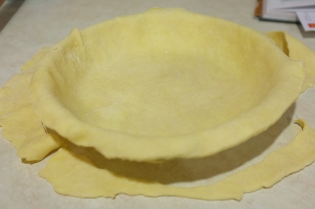To make the edges keep from looking crumby, I roll it out almost to pie-pan size and then shape it back into a disc and re-roll it.